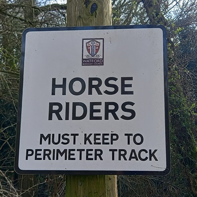 Photograph of Watford Borough Council sign asking horse riders to keep to the perimeter track